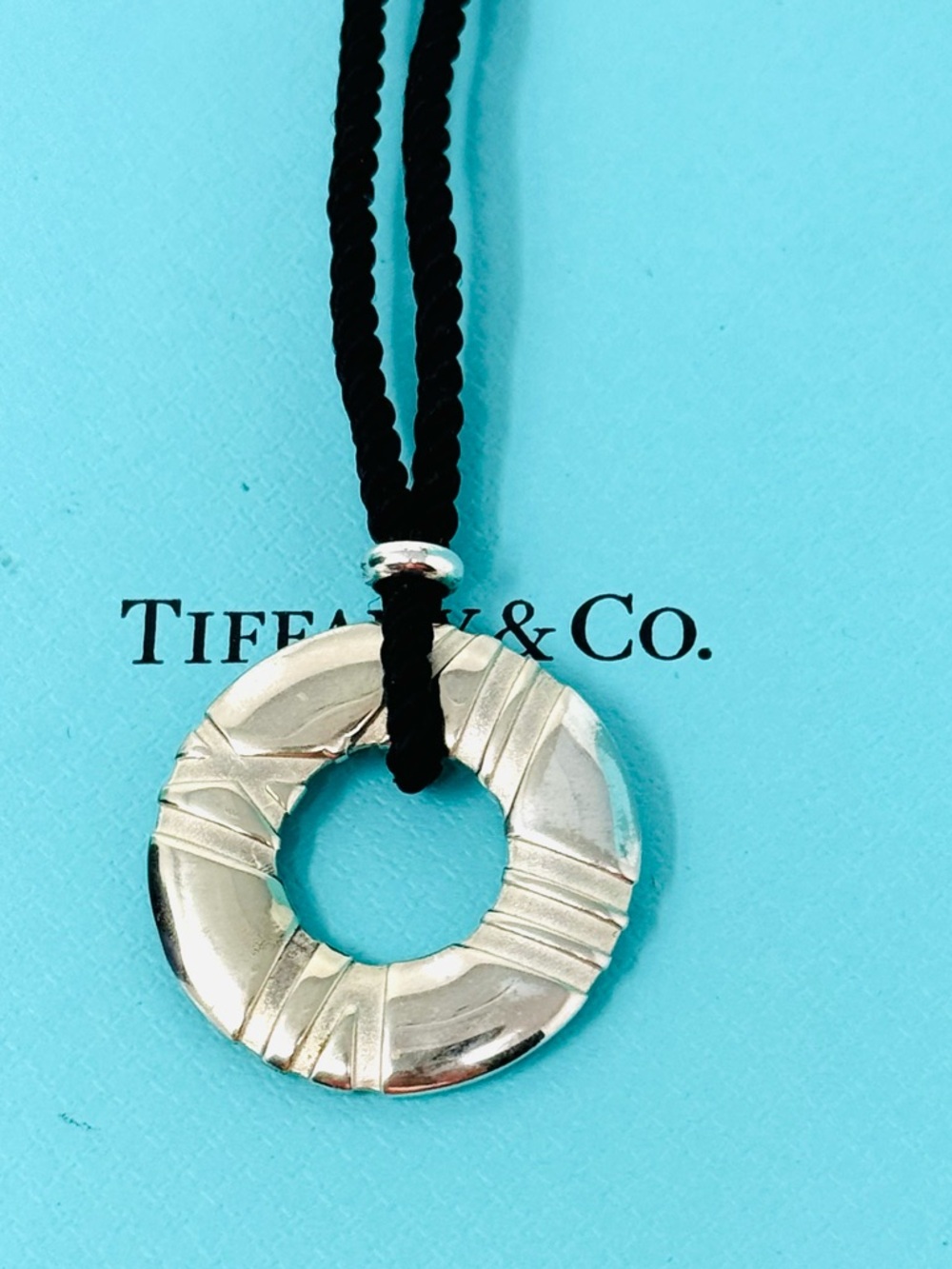 Authentic Tiffany & Co. Atlas  Numerical Round Pendant Silk Rope Cord Necklace.